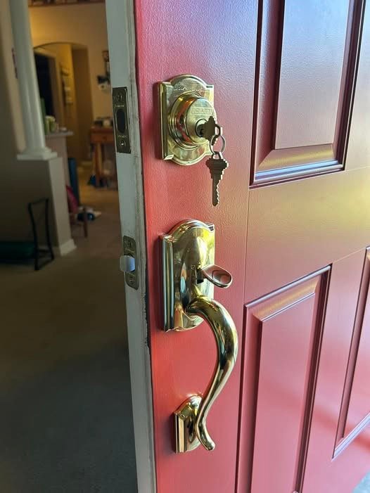 Red door with new locks by West Florida Locks
